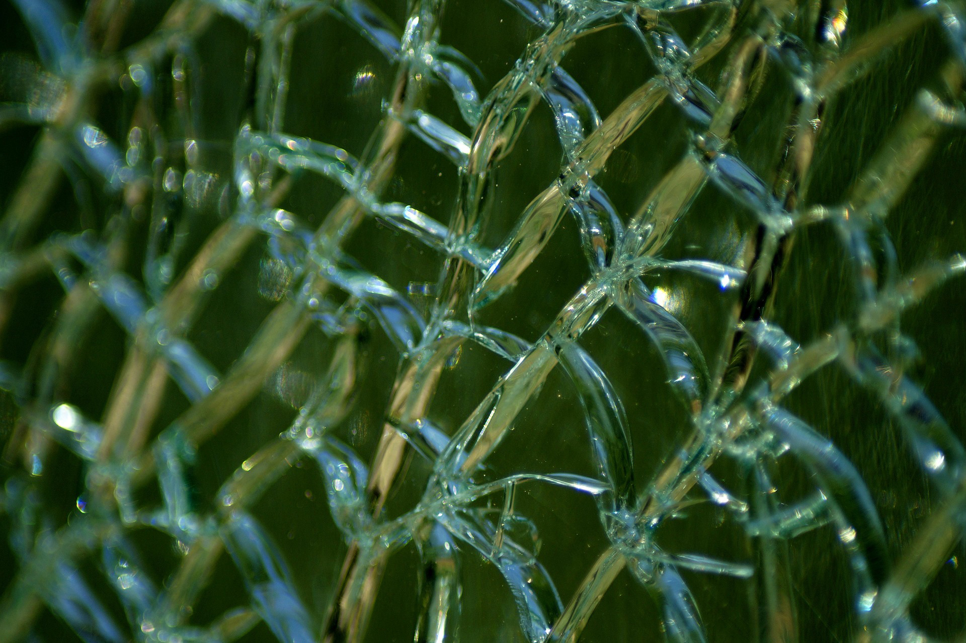 Close-up of cracked tempered glass showing blunt granules.